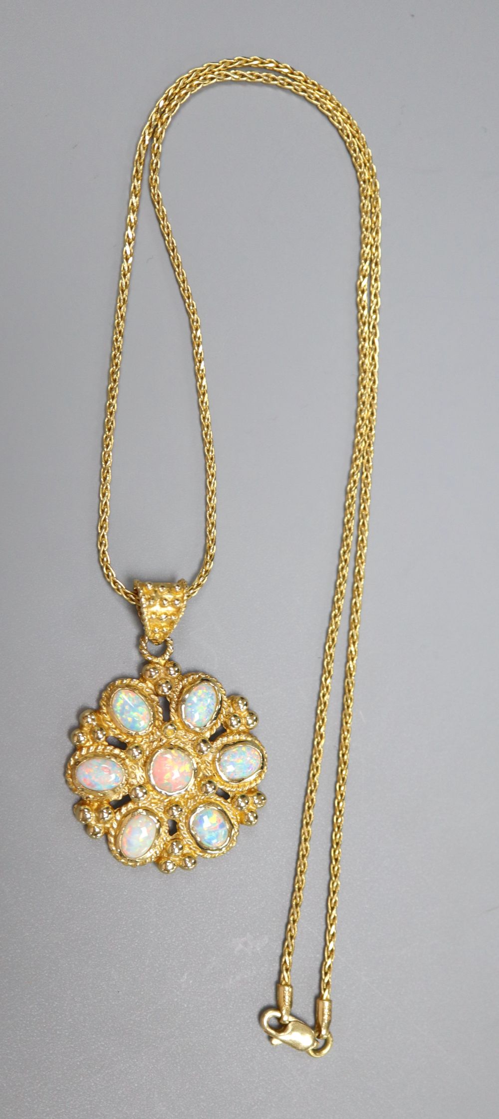 A Turkish 585 and white opal flowerhead pendant on chain by Istor, 13.4g